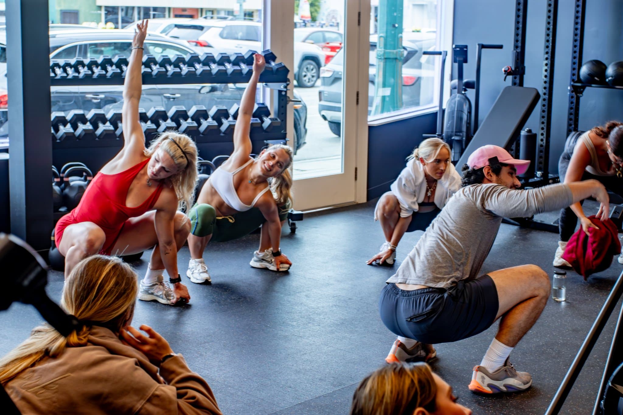 Small group strength training class in session — barbell work